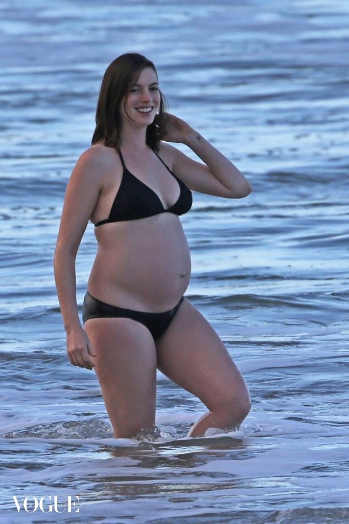 EXCLUSIVE: ** PREMIUM EXCLUSIVE RATES APPLY ** A bikini clad and pregnant Anne Hathaway takes a sunset dip in the ocean with her husband Adam Shulman while vacationing in Hawaii.