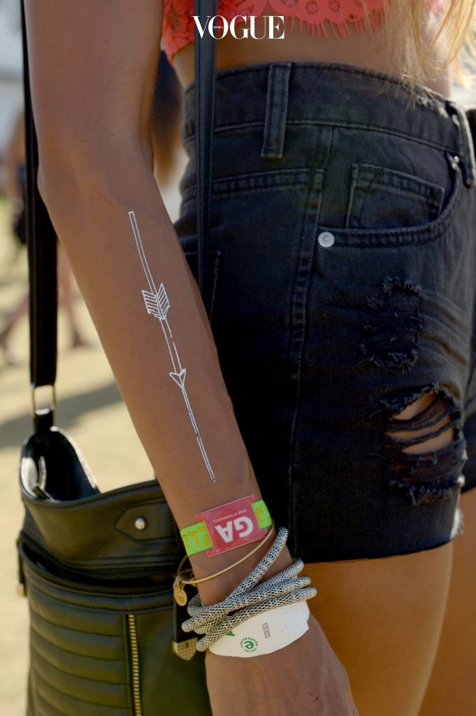 INDIO, CA - APRIL 18:  Music fans wearing metallic temporary tattoos attend day 2 of the 2015 Coachella Valley Music And Arts Festival (Weekend 2) at The Empire Polo Club on April 18, 2015 in Indio, California.  (Photo by Matt Cowan/Getty Images for Coachella)