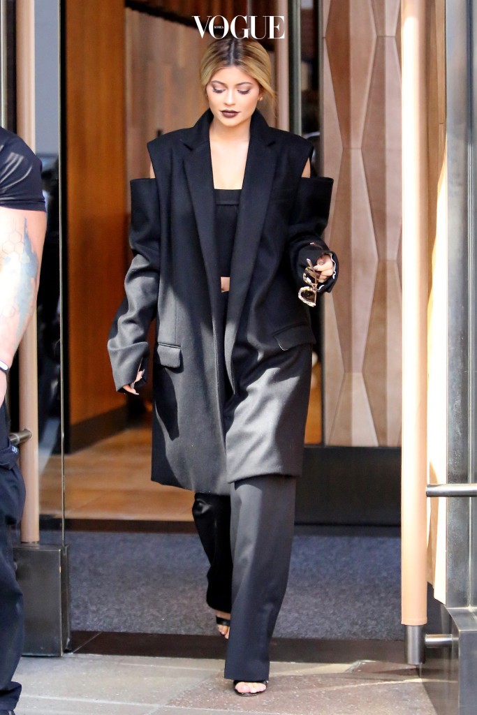 UK CLIENTS MUST CREDIT: AKM-GSI ONLY New York, NY - Kylie Jenner exits the Trump Hotel in SoHo covered up in a loose three quarter coat with the shoulders cut out with a crop top and black trousers.  The teenage reality star covered up for a change for today' Fashion Week festivities, but perhaps it's just a little cold today. Pictured: Kylie Jenner Ref: SPL1127253  150915   Picture by: AKM-GSI / Splash News 