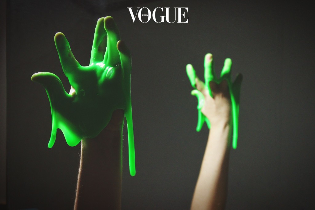Cropped Hand With Green Slime Against Black Background