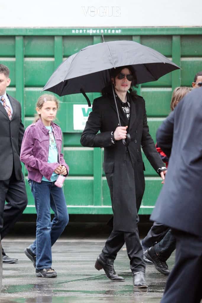 Michael Jackson walks with kids Prince and Paris through a studio parking lot in Los Angeles. The singer had been spotted with his entourage going to a studio on a cold rainy day in LA. Walking through the lot, the kids initially didn't have their usual masks on, it was only after they realized that they could be seen from the street that the kids emerged from a building wearing masquerade type masks. Michael stayed at the studio for over two hours, and there were many production people working around him suggesting that MJ was filming. After some time Michael emerged carrying his own umbrella before getting into his limo and being driven off. Pictured: Michael Jackson and Paris  Ref: SPL104102  030609   Picture by: Splash News Splash News and Pictures Los Angeles:310-821-2666 New York:212-619-2666 London: 870-934-2666 photodesk@splashnews.com 