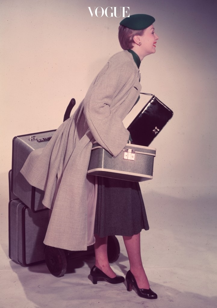 circa 1955:  A woman starts off on a journey with a full set of luggage - two suitcases, a handbag and a beauty case.  (Photo by Chaloner Woods/Getty Images)