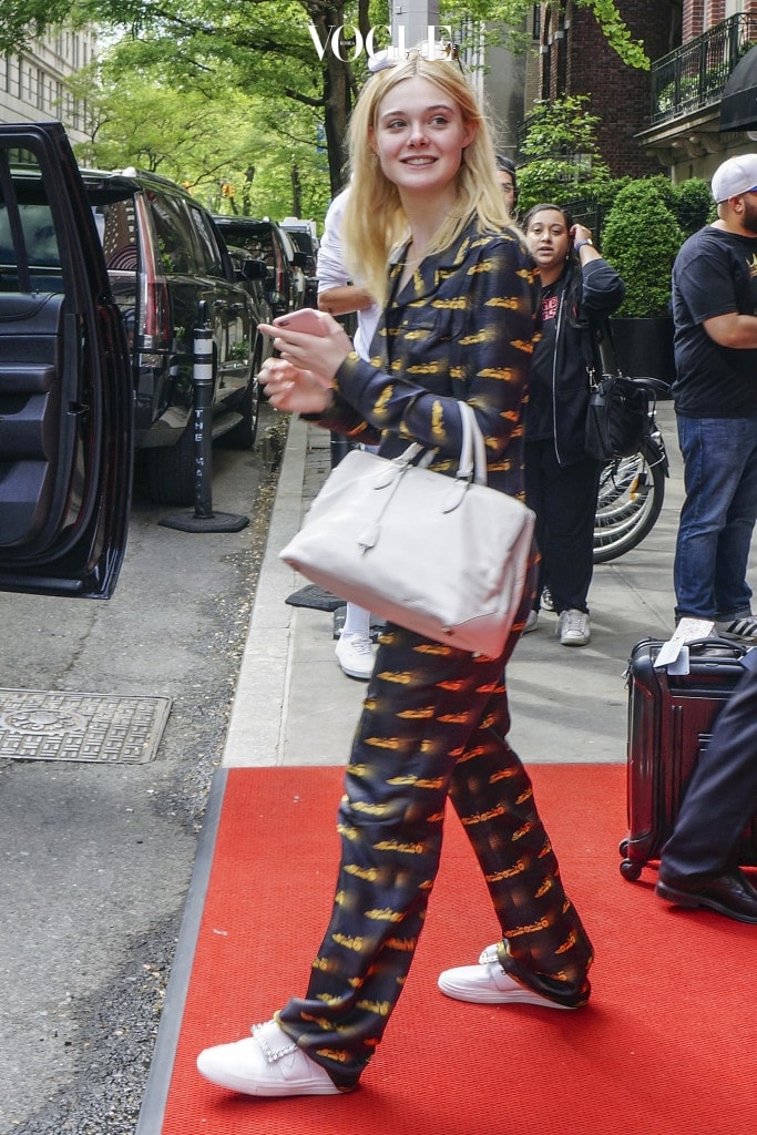 EXCLUSIVE: Elle Fanning departs New York in silk race car pajamas! The young actress was happy and smiling and paired her look off with bejeweled white sneakers and grey leather handbag. The silk pajamas were also monogrammed on the chest. Pictured: dakota fanning Ref: SPL1489714  040517   EXCLUSIVE Picture by: Splash News Splash News and Pictures Los Angeles:310-821-2666 New York:212-619-2666 London:870-934-2666 photodesk@splashnews.com 