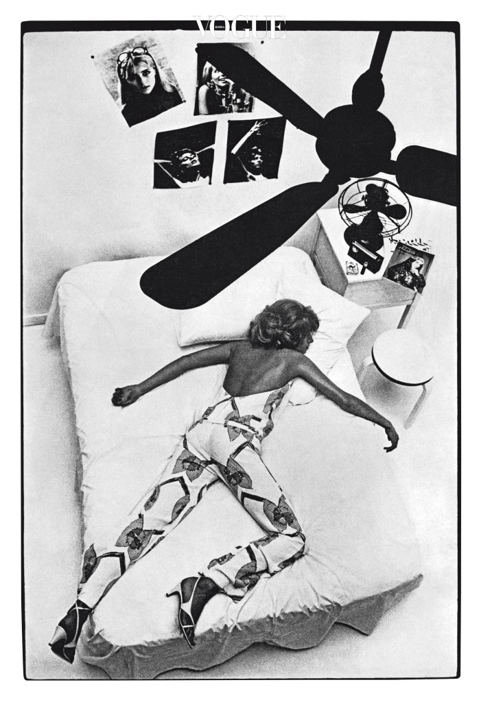 UK Archive British Vogue July 1965 p64 Helmut Newton Model lies across bed sleeping, wearing printed crepe jumpsuit, ceiling fan, holiday heatwave fashion shoot.