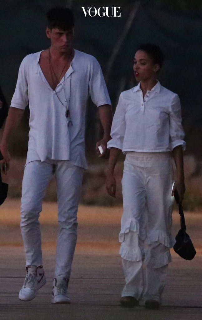 EXCLUSIVE: **PREMIUM EXCLUSIVE RATES APPLY** NO WEB TILL 9.15PM PST 11th AUGUST 2017* FKA Twigs steps out with a hunky French male model amid rumours fiance Robert Pattinson is dating Katy Perry.  The 29-year-old singer - real name Tahliah Barnett - jetted off to Ibiza with Brieuc Breitenstein just days after Twilight star Pattinson was spotted at dinner with Perry. The 6ft 3ins model, who is thought to originally be from Paris and now lives in London, was seen cosying up to her as they went sightseeing on the Spanish island.  And there was no sign of the engagement ring that Pattinson is said to have given to her. They got caught in a rainstorm at one point - and were seen going out the previous night in matching white outfits. An onlooker said: "They looked like a couple." FKA Twigs and Robert, 31, reportedly got engaged in 2015. But as recently as last month he admitted they were "kind of engaged" as he chatted on Sirius XM's The Howard Stern radio show. Pictured: FKA Twigs, Brieuc Breitenstein Ref: SPL1554480  110817   EXCLUSIVE Picture by: Splash News Splash News and Pictures Los Angeles:310-821-2666 New York:212-619-2666 London:870-934-2666 photodesk@splashnews.com 