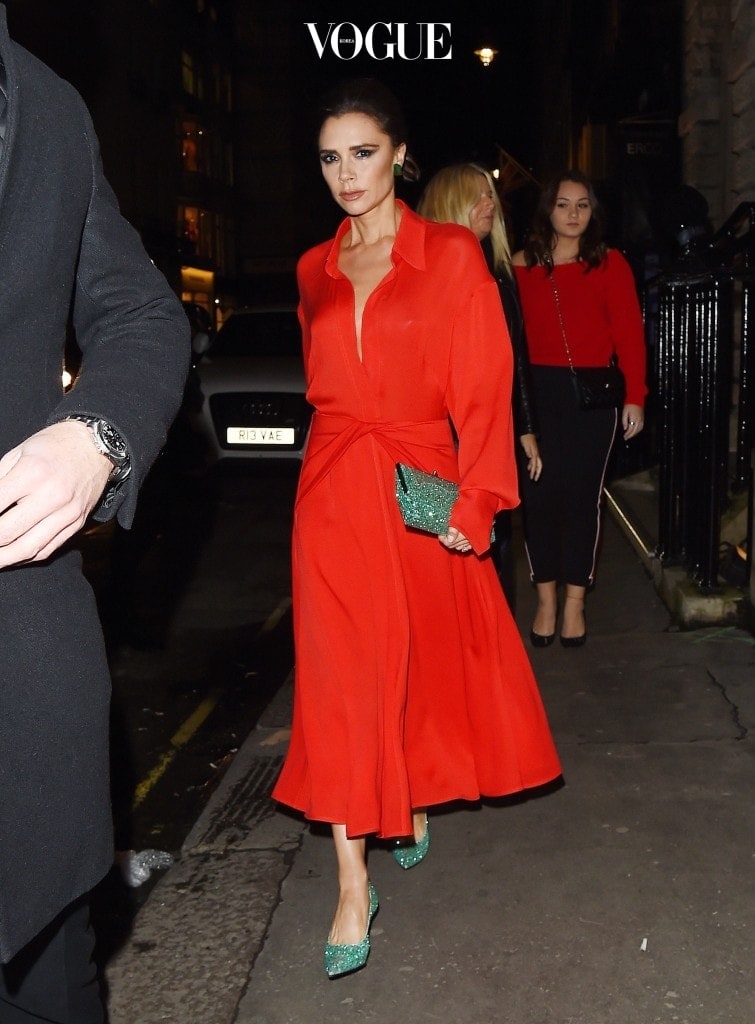 EXCLUSIVE: Victoria Beckham seen arriving at her store for British Vogue Kisses at Christmas in London, England. The fashion designer was looking festive in a red midi dress paired with a green glittery clutch and matching heels. Pictured: Victoria Beckham Ref: SPL1637908  141217   EXCLUSIVE Picture by: Flynet - Splash News Splash News and Pictures Los Angeles:310-821-2666 New York:212-619-2666 London:870-934-2666 photodesk@splashnews.com 